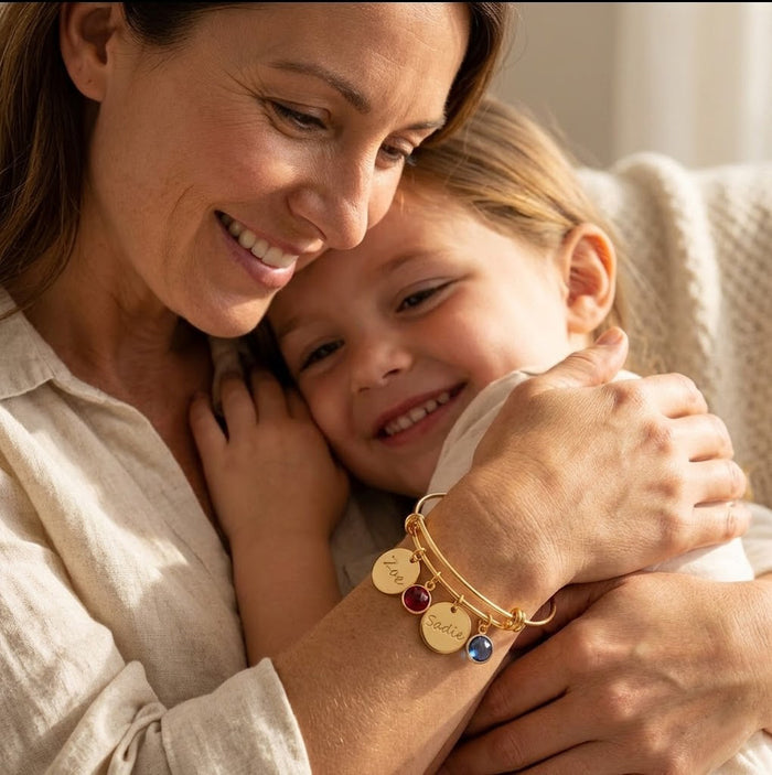 custom engraved bangle bracelet with name charms and birthstones, personalized jewelry on mom hugging her child