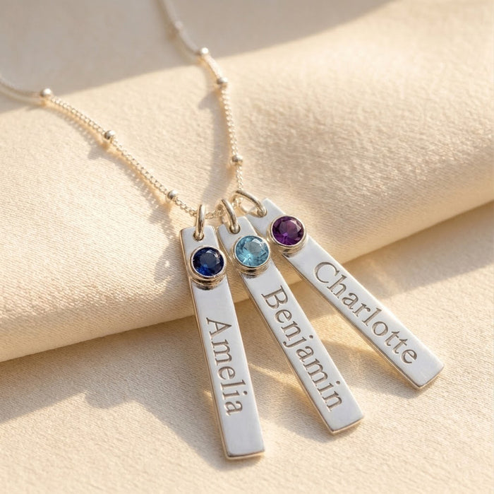 Personalized name bar birthstone necklace with engraved charms and blue gemstones in sterling silver