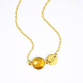 Single gold filled citrine birthstone november birthstone jewelry necklace with brushed initial disk on a white background.