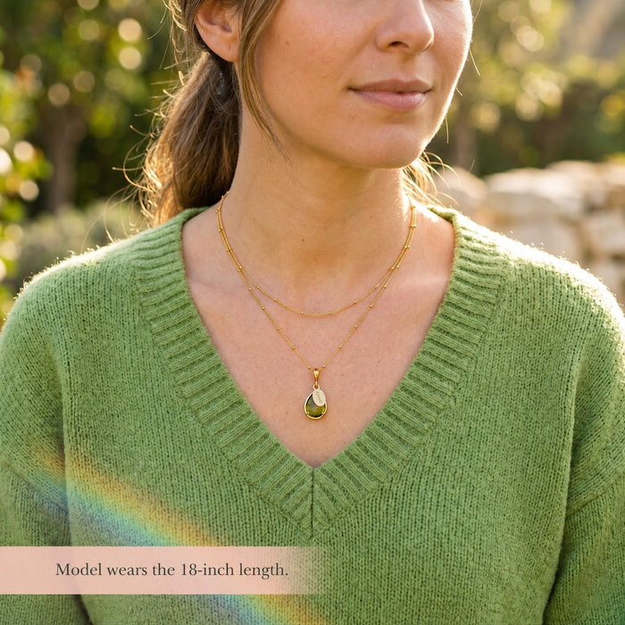 Model wearing an 18 inch personalized peridot necklace with engraved name tag, a dainty August birthstone necklace for everyday jewelry.
