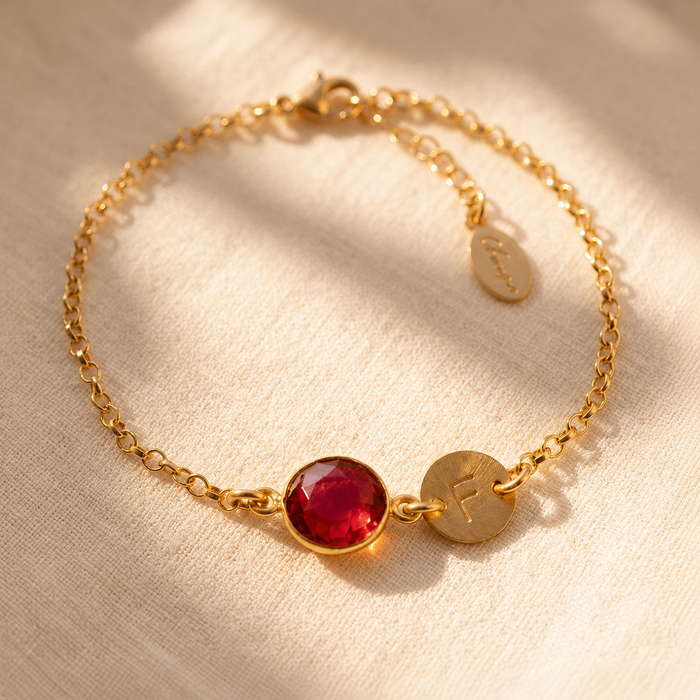 Personalized ruby initial bracelet with 10 mm faceted July birthstone and gold letter disc