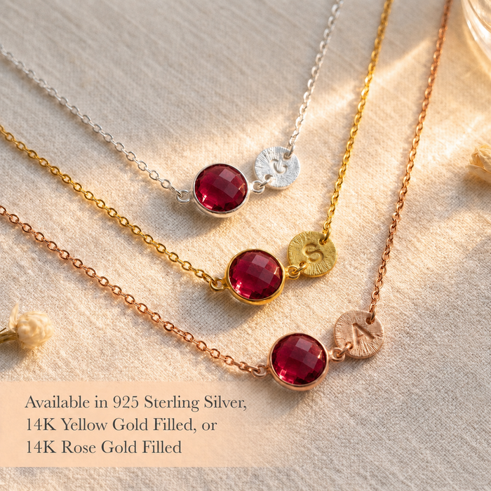 Ruby initial necklaces displayed in sterling silver, yellow gold, and rose gold finishes