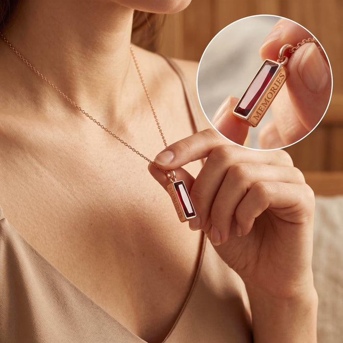 Close-up of ruby baguette necklace showing hidden side engraving detail.
