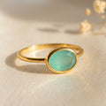 a gold aqua chalcedony ring shown on white background. Stacking rings, bezel set, small oval, tiny oval, dainty oval, birthstone rings, sterling silver stamp, birthstone ring, birthstone jewelry, march birthstone, march gemstone, stack set, stacking rings, gemstone ring, birthstone ring, mother's day gift for her, gift for mom, gift for fiance, gift for girlfriend, wedding jewelry, bridesmaid jewelry, anniversary jewelry, anniversary gift, birthday gift, christmas gift, valentine's day gift