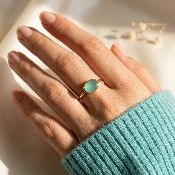 a sterling silver aquamarine ring shown on a hand. Stacking rings, bezel set, small oval, tiny oval, dainty oval, birthstone rings, sterling silver stamp, birthstone ring, birthstone jewelry, march birthstone, march gemstone, stack set, stacking rings, gemstone ring, birthstone ring, mother's day gift for her, gift for mom, gift for fiance, gift for girlfriend, wedding jewelry, bridesmaid jewelry, anniversary jewelry, anniversary gift, birthday gift, christmas gift, valentine's day gift