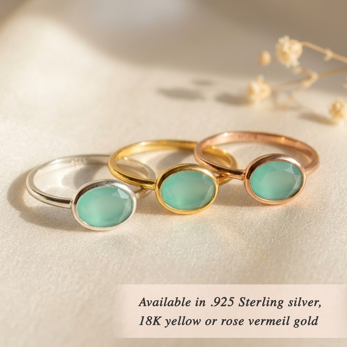 Dainty gold aquamarine ring stacked with other birthstone rings