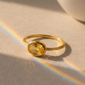 Small oval citrine birthstone ring featuring a golden November gemstone in a minimalist setting, handcrafted in sterling silver or gold vermeil.
