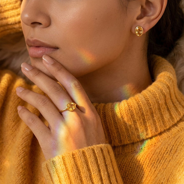 Model wearing a dainty citrine ring with a cozy golden sweater, highlighting the warm yellow November birthstone and minimalist design, perfect for a birthday gift, mom gift, or everyday stackable ring.