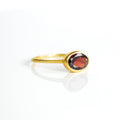 a gold garnet ring shown on white background. stackable! Stacking rings, bezel set, birthstone jewelry, red gemstone, red birthstone, january birthstone, january gemstone, stack set, stacking rings, gemstone ring, birthstone ring, mother's day gift for her, gift for mom, gift for fiance, gift for girlfriend, wedding jewelry, bridesmaid jewelry, anniversary jewelry, anniversary gift, birthday gift, christmas gift, valentine's day gift, valentine's day rings, dainty ring, cocktail ring, statement ring