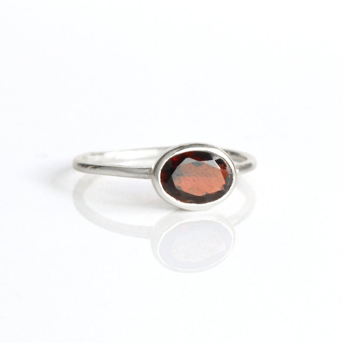a sterling silver garnet ring shown on white background. stackable! stack set, stacking rings, gemstone ring, birthstone ring, mother's day gift for her, gift for mom, gift for fiance, gift for girlfriend, wedding jewelry, bridesmaid jewelry, anniversary jewelry, anniversary gift, birthday gift, christmas gift, valentine's day gift, valentine's day rings, dainty ring, cocktail ring, statement ring, bezel set, birthstone jewelry, birthstone ring