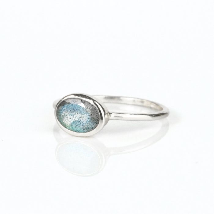 a sterling silver labradorite ring shown on white background. stackable! Stacking rings, bezel set, small oval, tiny oval, dainty oval, birthstone rings, sterling silver stamp, birthstone ring, birthstone jewelry, iridescent gemstone, gray birthstone