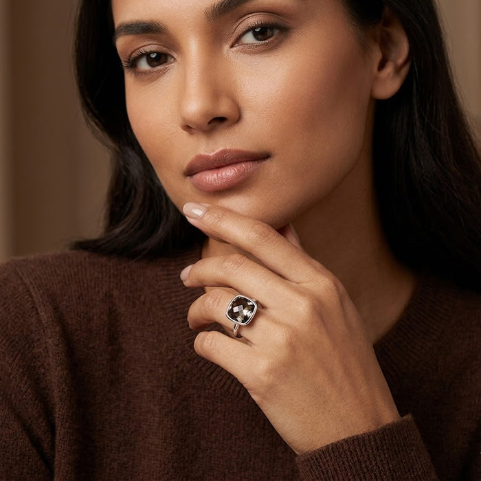 Cushion smoky quartz ring styled with layered gemstone rings on hand