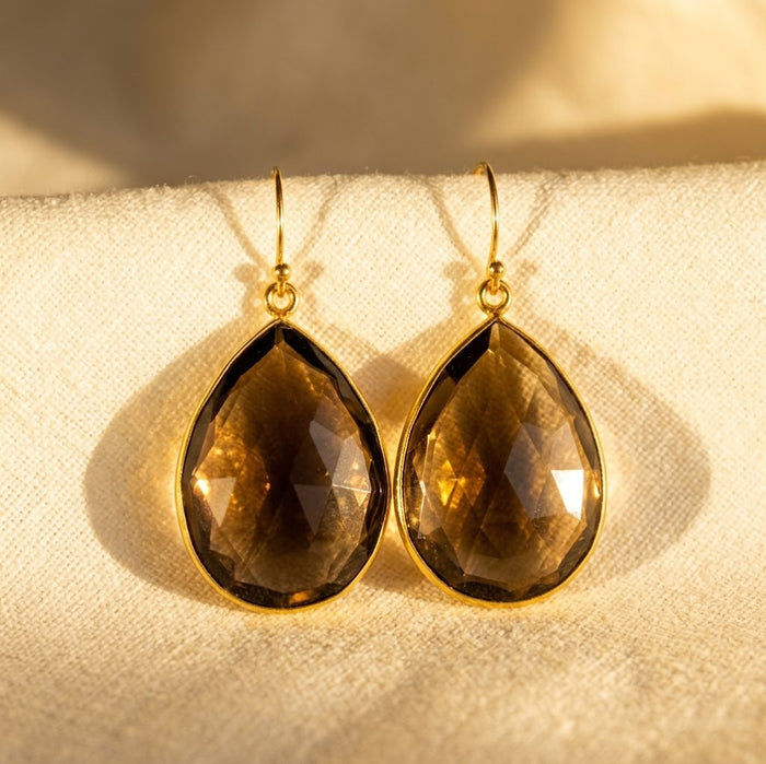 Smoky quartz teardrop earrings in gold bezel setting with faceted brown gemstone