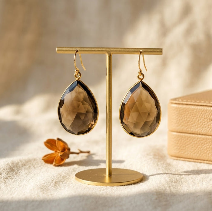 Smoky quartz earrings set in gold with teardrop shape and rich brown crystal
