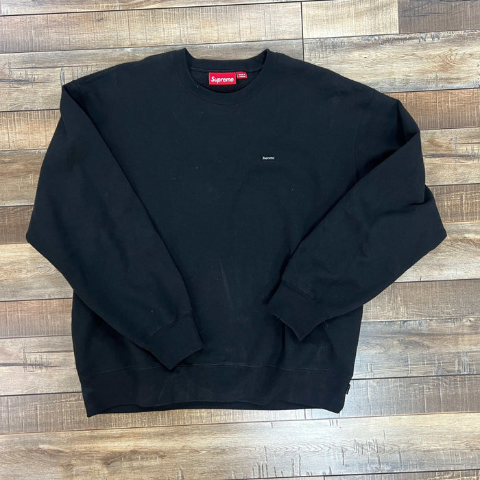 Black Supreme Small Box Crewneck sweatshirt laid flat on wooden floor preowned
