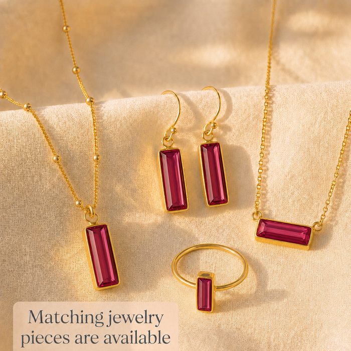 Matching ruby quartz jewelry set with ring, necklace, and earrings.