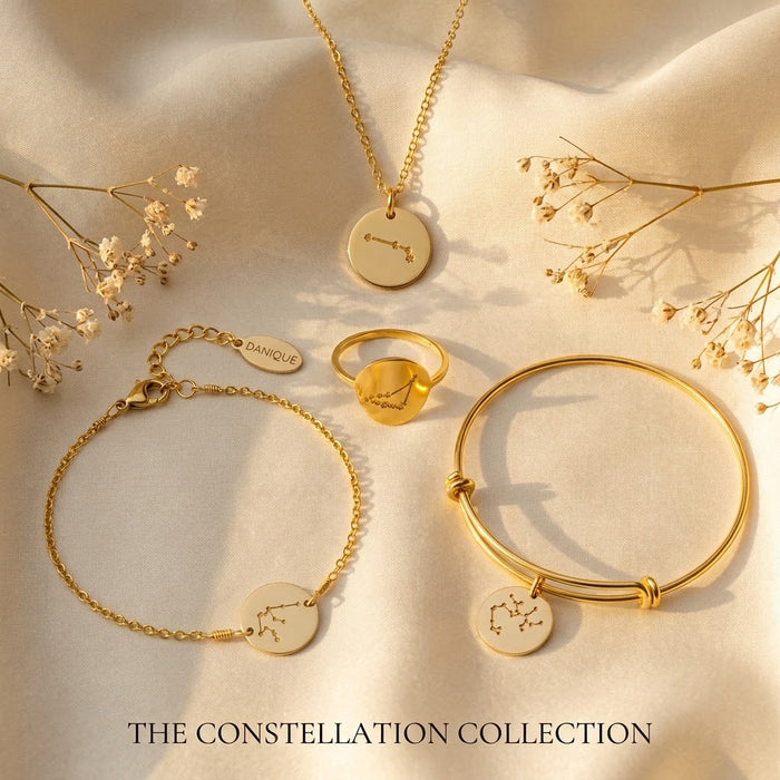 Matching constellation jewelry set with necklace, bracelet, and ring in yellow gold finish.